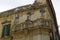 Charming balcony with baroque statues as example of typical architecture in Lecce