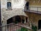 Charming balcony in a historic building, adorned with plants and terracotta planters