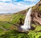 Charming beautiful waterfall Seljalandsfoss in Iceland. Exotic countries. Amazing places. Popular tourist atraction