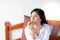 Charming beautiful woman is eating green apple instead breakfast because pretty woman wants to diet. Attractive asian woman just