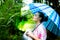 Charming beautiful woman hold a umbrella in rainy day at beautiful park. Gorgeous caucasian woman inhale fresh air. Lovely