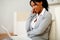 Charming black woman sitting on the floor