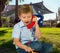 Charming blond boy speaks on telephone