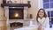 Charming blonde lays on floor near fireplace