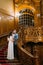 Charming bride and handsome elegant groom embracing on old stairs with the background of gorgeous wooden vintage