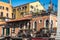 Charming building with potted plants on balconies and roof top deck in Venice, Italy