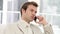 Charming businessman talking seriously on phone