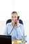 Charming businesswoman talking on phone sitting