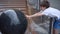 Charming caucasian boy having fun with fountain shot during summer time