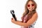 Charming Caucasian teen video blogger shoots video on the phone with a flash device on a white background