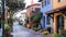 A charming cobblestone street lined with colorful quaint houses showcasing a mix of traditional and modern architectural