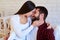 Charming couple tenderly embracing and touching foreheads while
