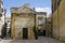 Charming courtyard with balcony with lush plants as example of typical baroque tenement house