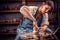 Charming craftsman master sculptor works with clay on a Potter& x27;s wheel and at the table with the tools. Handicraft