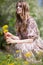 Charming cute girl in a light dress with bright colors in the city Park