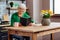 Charming dame with silver hair reading Bible at kitchen table