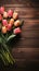 Charming display Tulips and notepad neatly placed on wooden table