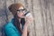Charming dreamy young girl drinking tea near concrete wall outdo