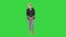 Charming elder woman in fashionable glasses standing and waiting on a Green Screen, Chroma Key.