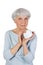 Charming elderly woman applying cosmetic cream on her face for facial skin care on a white background