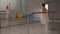 Charming female ballerina in front of the mirror at the rehearsal pulls her leg high, helps with her hand