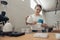 Charming female barista making filter coffee in cafeteria