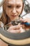 Charming female mechanic repairing the chain of the bicycle