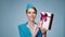 A charming flight attendant holds gift box in her hands. Duty free.