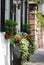 Charming front of house with overflowing planter boxes in downtown Charleston, SC.