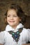 Charming girl child in a white blouse with a beautiful necklace