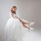 Charming girl in magnificent wedding dress and white sneakers. Runaway bride