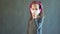 Charming girl in a mask with headphones listens to music