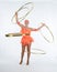 A charming girl performs circus elements with a hula Hoop