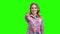 Charming girl showing thumb up on green screen.