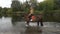 Charming girl sitting on a horse and rides on the Lake