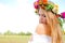 Charming girl wearing flower wreath and white