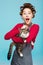 Charming girl with wide smile with cat in hands poses