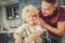 Charming glad boy and man funning with flour