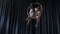 Charming gymnasts sits and spins in the aerial hoop
