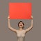 Charming happy woman holding big red paper empty blank.