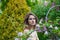 Charming healthy woman posing outdoor in spring park, closeup portrait