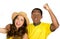 Charming interracial couple wearing yellow football shirts cheering joyfully to camera, white studio background
