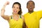 Charming interracial couple wearing yellow football shirts cheering joyfully to camera, white studio background