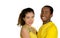 Charming interracial couple wearing yellow football shirts, embracing friendly while posing for camera, white studio