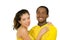 Charming interracial couple wearing yellow football shirts, embracing friendly while posing for camera, white studio