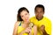 Charming interracial couple wearing yellow football shirts holding small trophy posing for camera, white studio