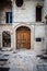 Charming Italian Balconies: Old Buildings Adorned Old Wooden Door in a Typical Polignano a Mare Street