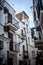 Charming Italian Balconies: White Buildings Adorned with Balconies in a Typical Polignano a Mare Street