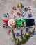 Charming joyful toddler girl in Santa hat and elf`s sweater lies on light carpet