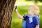 Charming kid exploring nature with magnifying glass